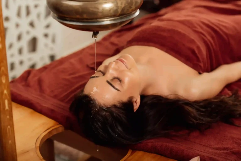 relaxed-young-woman-lying-under-shirodhara-vessel-2023-11-27-04-56-31-utc-copy-scaled_11zon